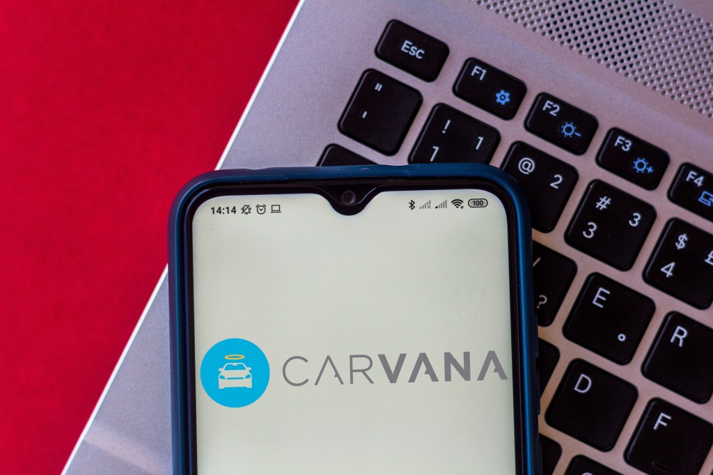 In this photo illustration, the Carvana logo is displayed on a smartphone. 