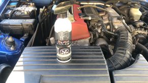 A bottle of Jay Leno's tire shine in an engine bay
