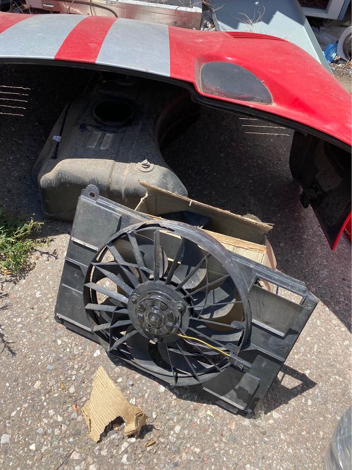 A picture of a radiator fan and hood from the red 2002 Dodge Viper for sale.