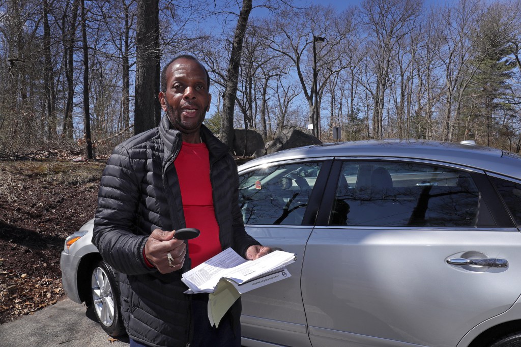A Nissan owner holds the remote key fob to his car.
