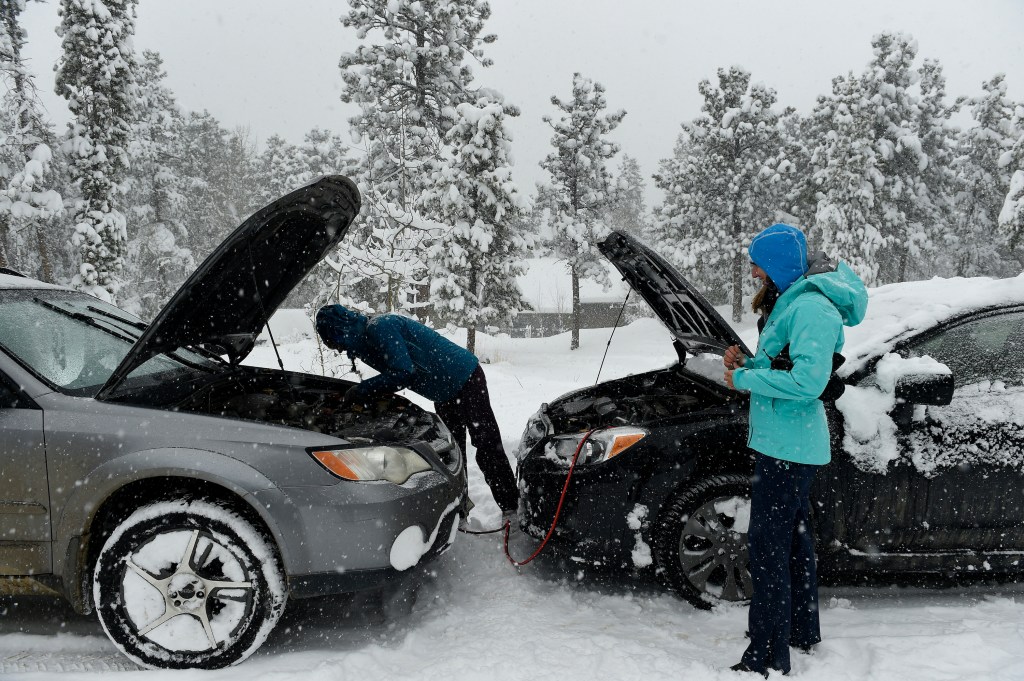 two cars get a jump start in the winter