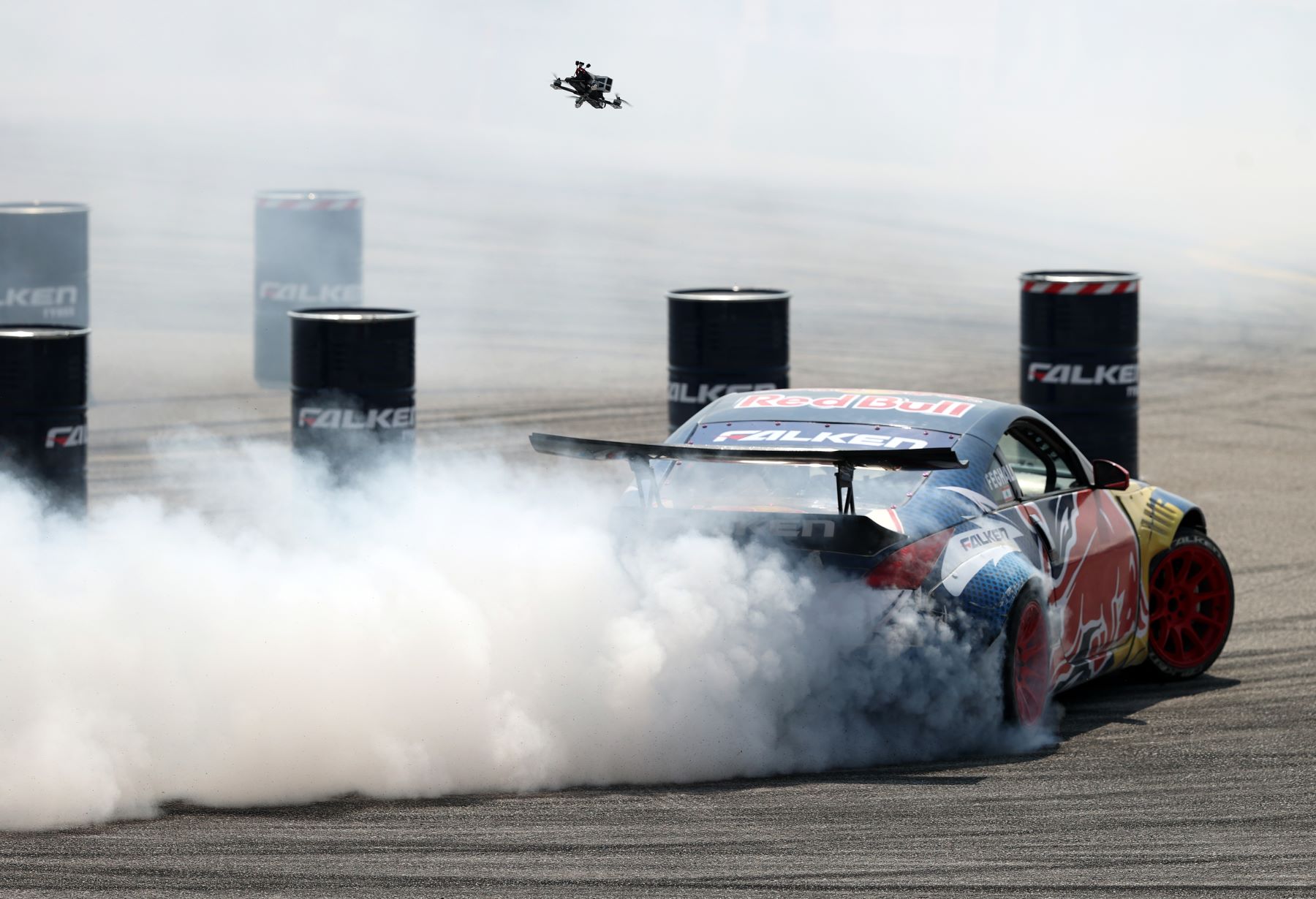 A racecar burning rubber as it drifts during a skill competition at the Red Bull Car Park Drift Turkey Finals in Bursa, Turkey