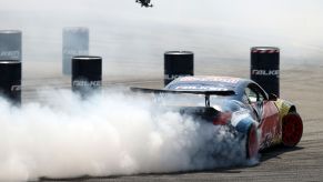 A racecar burning rubber as it drifts during a skill competition at the Red Bull Car Park Drift Turkey Finals in Bursa, Turkey