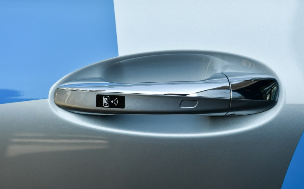  The door handle of a Mercedes EQC 400, Daimler's first all-electric SUV, shows a symbol for the keyless entry system Keyless-Go for opening, closing, starting, and stopping without touching the ignition key.