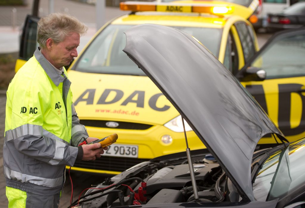 A service worker starts a car battery