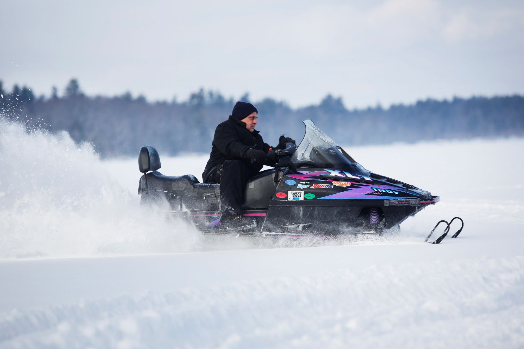 A snowmobile being driven across a frozen lake in Somerville, Massachusetts