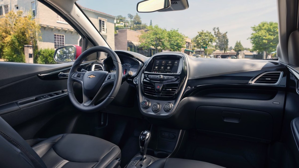 Chevrolet Spark interior view showing dashboard, steering wheel and infotainment screen.
