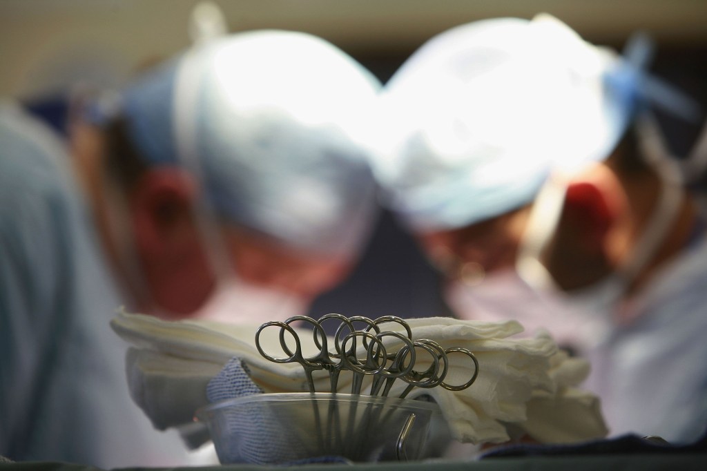 Surgeons at The Queen Elizabeth Hospital Birmingham conduct an operation.