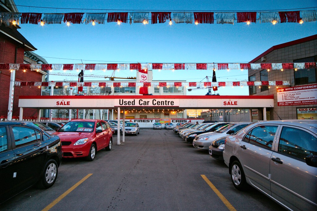 used luxury cars are hard to buy. This car lot is stacked with used cars.