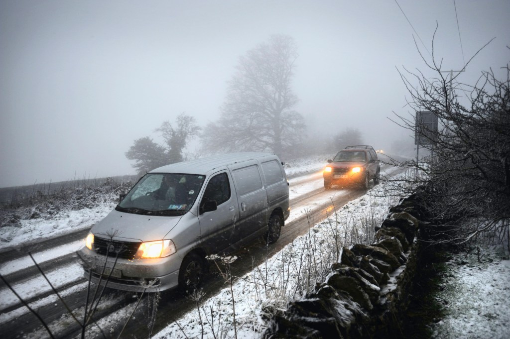 A van drives on a snowy road in the UK 