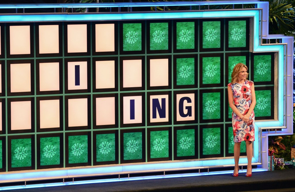 Vanna White standing next to the "Wheel of Fortune" game board