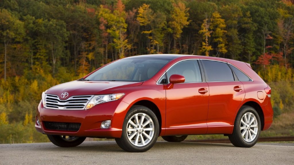 Red 2009 Toyota Venza with forest background