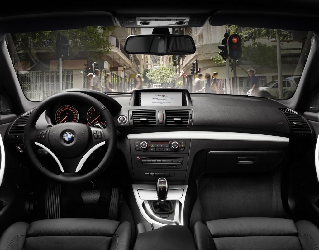 The black front seats and dashboard of a 2012 E82 BMW 135i Coupe