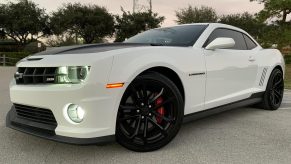 The front 3/4 view of a white-and-black 2013 Chevrolet Camaro SS 1LE
