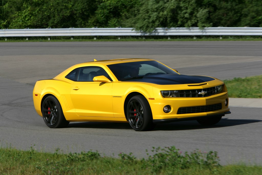 A yellow 2013 Chevrolet Camaro SS 1LE goes around a racetrack