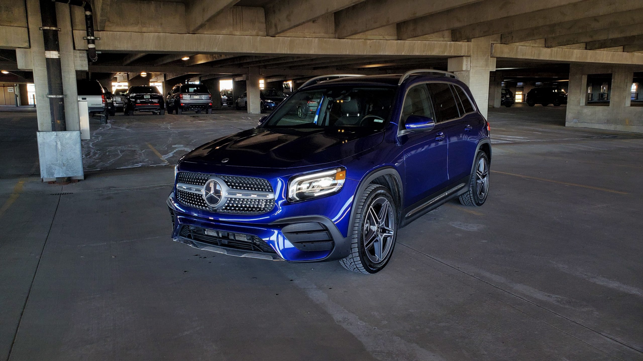 A Galaxy Blue 2021 Mercedes-Benz GLB 250 SUV shot from the front 3/4