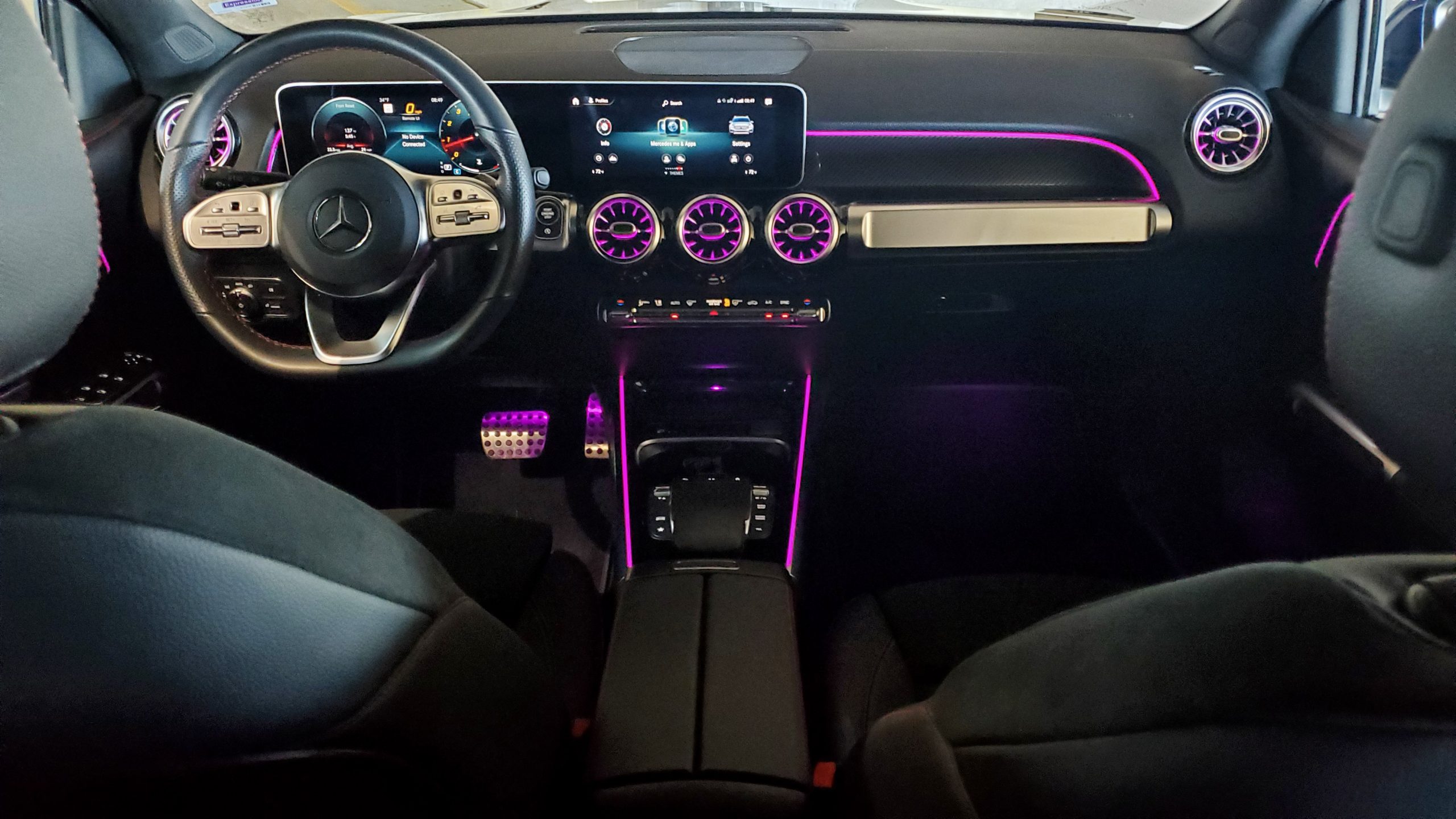 The black leather interior of the GLB 250 with purple ambient lighting