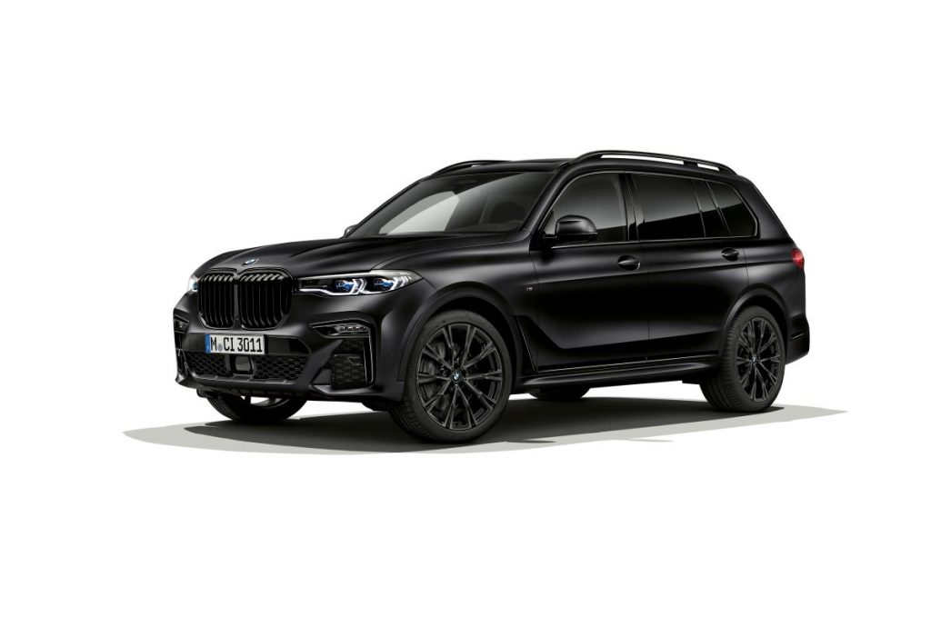 A black 2022 BMW X7 in a solid white room.