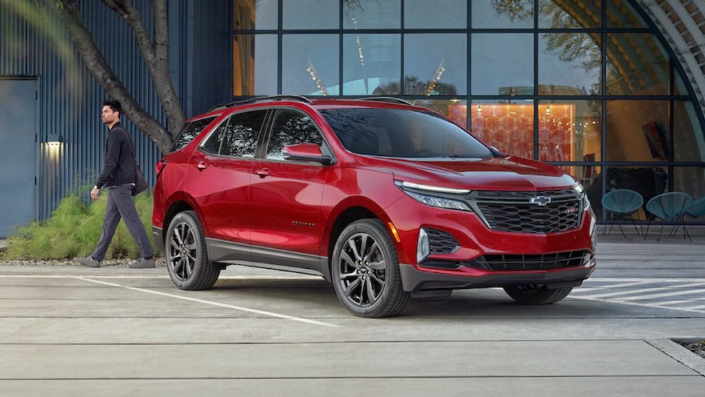 Red 2022 Chevrolet Equinox SUV next to a building