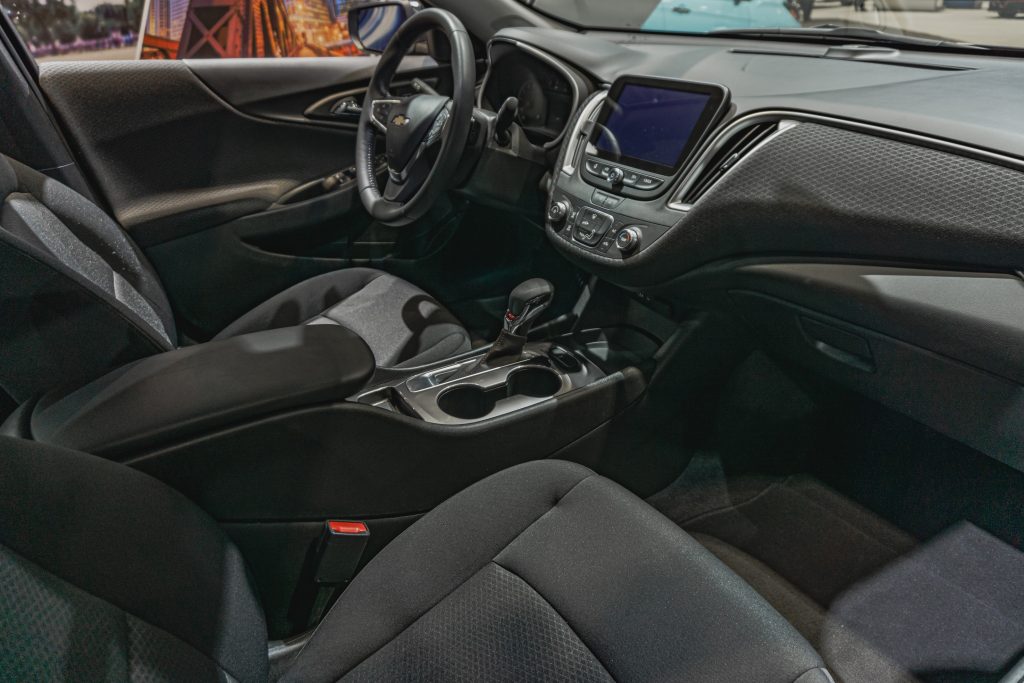 The gray-cloth front seats and gray dashboard of a 2022 Chevrolet Malibu RS