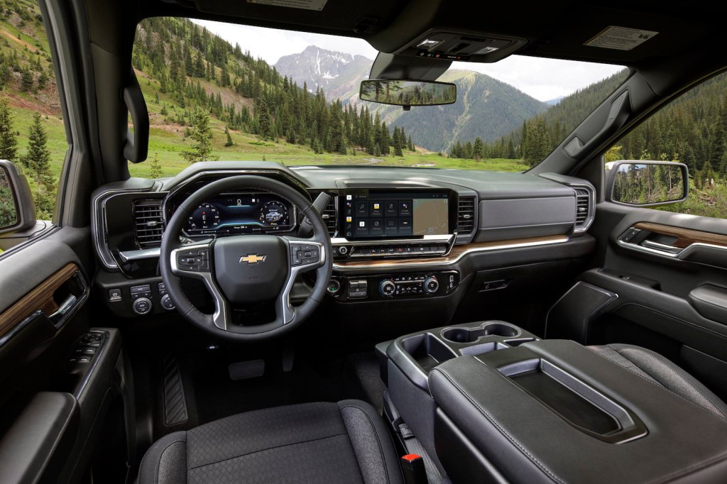 The black leather interior of a brand-new Chevy Silverado parked in the Rocky Mountains.