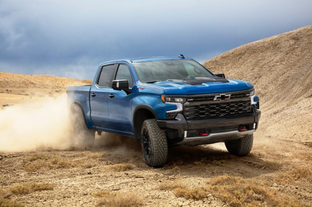 A blue 2022 Chevy Silverado ZR2 is a better buy than the Ford Raptor or Ram TRX pickup trucks