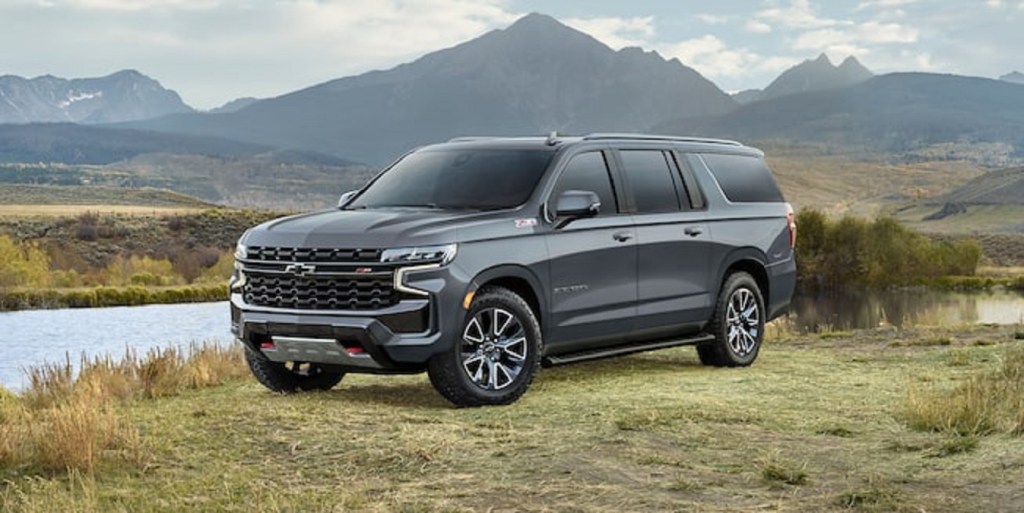 A gray 2022 Chevy Suburban parked in front of a mountain.