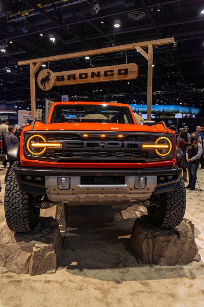 The front view of an orange 2022 Ford Bronco Raptor at the 2022 Chicago Auto Show