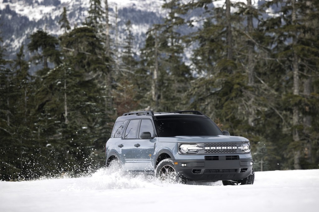 A gray 2022 Ford Bronco Sport crossover SUV drives in the snow in the wildnerness