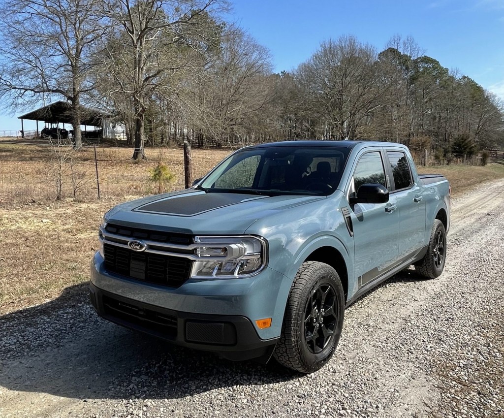 A blue 2022 Ford Maverick First Edition on a gravel road.