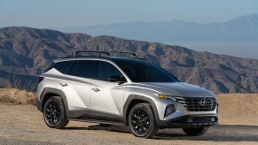 A silver 2022 Hyundai Tucson XRT parked in front of mountains