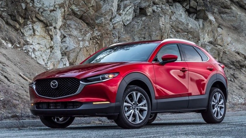 Red 2022 Mazda CX-30 posed by cliff