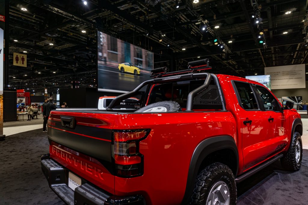 The rear 3/4 view of the red-and-black 2022 Nissan Frontier Project Hardbody at the Chicago Auto Show