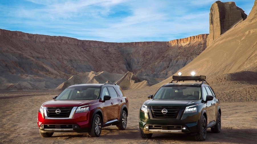 Two 2022 Nissan Pathfinder SUVs parked next to each other in a desert