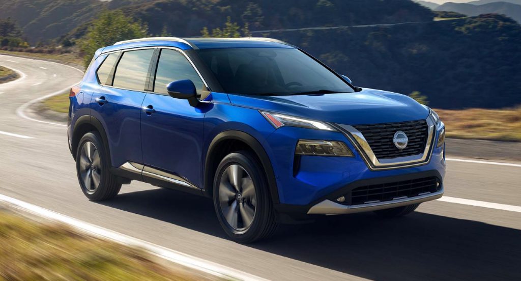 A blue 2022 Nissan Rouge small SUV is driving on the road. 