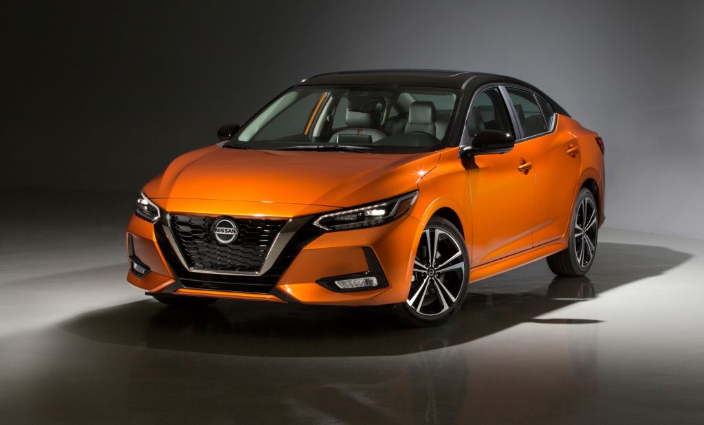 An orange 2022 Nissan Sentra in a black and white room