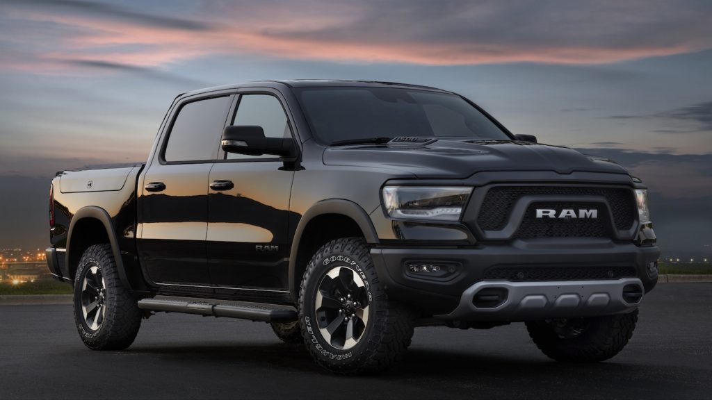 Black Ram rebel pickup truck with G/T badges, parked with the sun setting in the background.