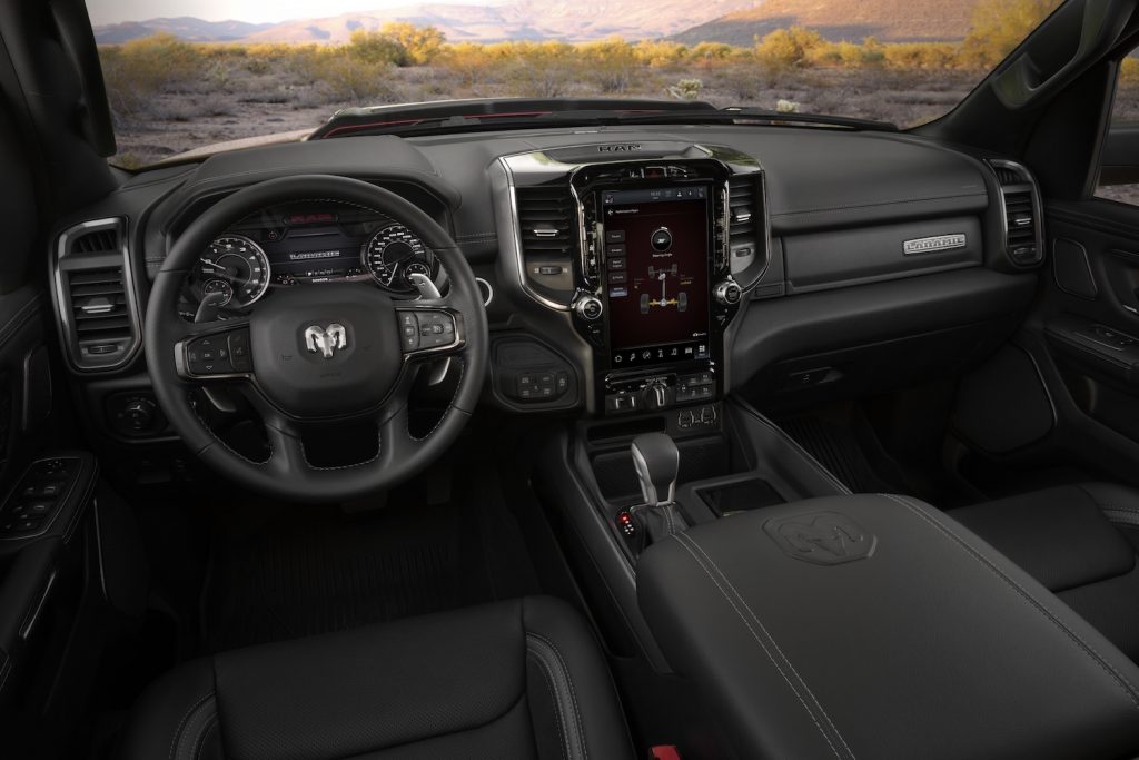Promo of the interior of a Ram 1500 Laramie truck with the G/T package, center console shift lever visible.
