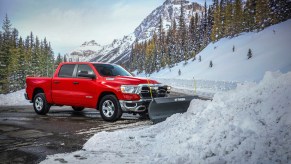 A red 2022 Ram 1500 in front of snow.