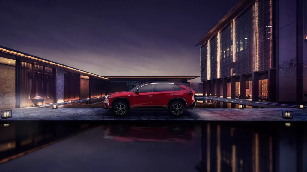 A red 2022 Toyota RAV4 Prime parked outside a house.