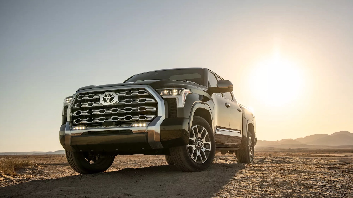 Promo shot of a 2022 Toyota Tundra pickup truck parked in a desert.