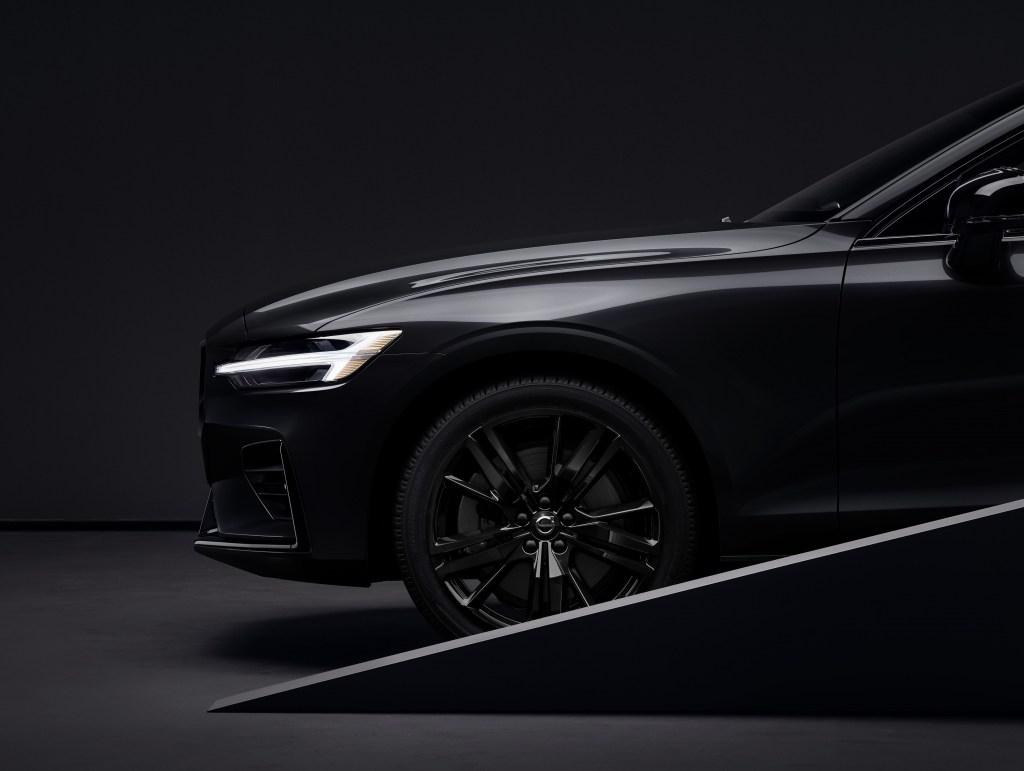 A close-up look at a black 2022 Volvo S60 Black Edition's front wheel