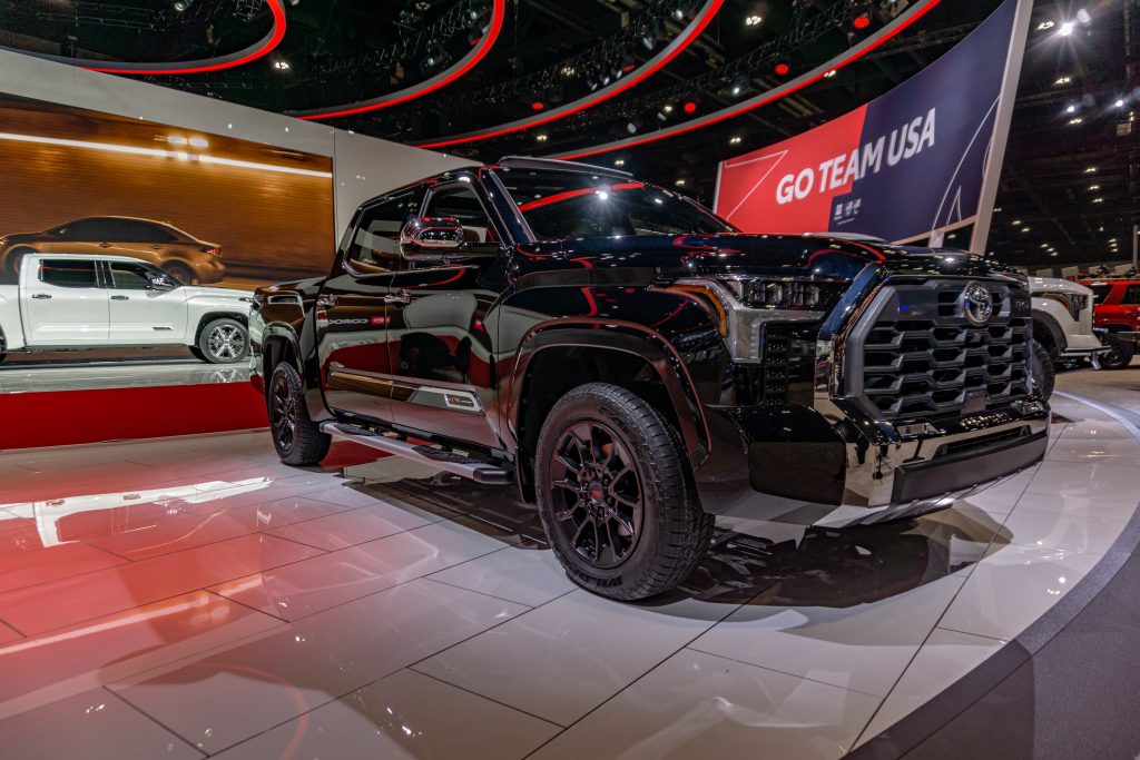 A black 2022 Toyota Tundra 1794 Edition with a white Capstone in the background at the 2022 Chicago Auto Show