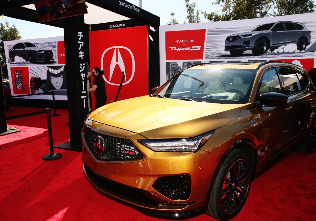The luxury SUV from Acura, an MDX, is on display at a car show.