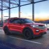 A red 2022 Ford Explorer driving on a bridge.