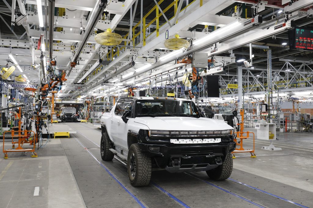 A GMC Hummer pickup trucks the production line in a factory.
