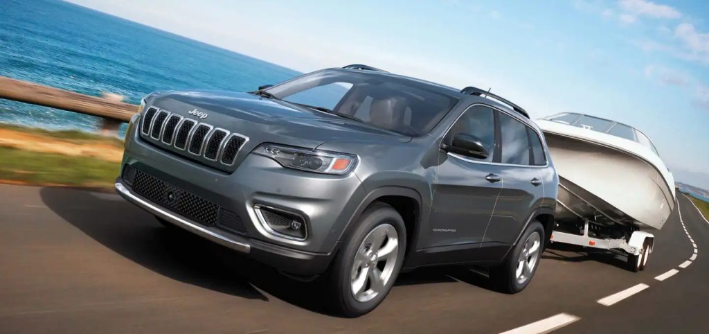 The 2022 Jeep Cherokee tows a boat, which shows it capability as a crossover.