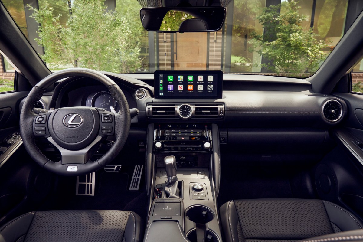 An interior view of a 2022 Lexus IS sedan showing the steering wheel, instruments, dashboard, and infotainment display.