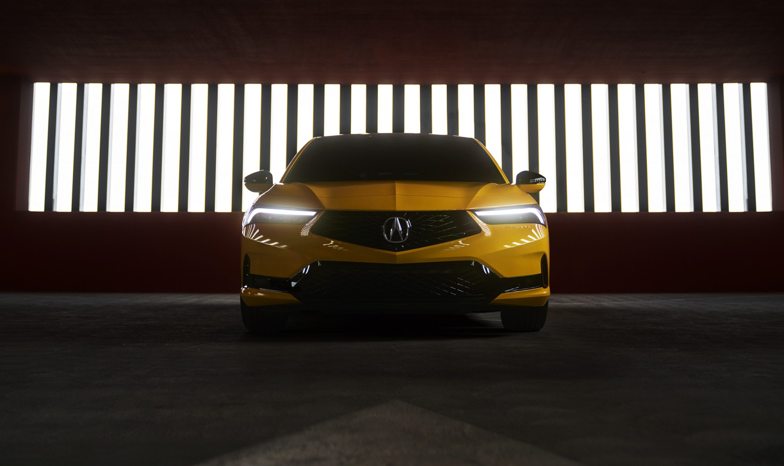 A front shot of the 2023 Acura Integra in yellow