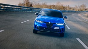 A bright-blue 2023 Alfa Romeo Tonale Veloce PHEV on a racetrack